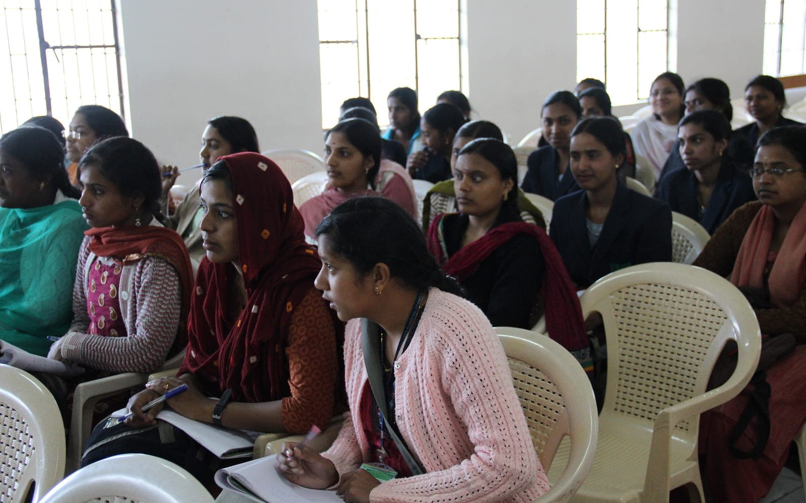 College students with notebooks listening at a workshop in Udhagamandalam